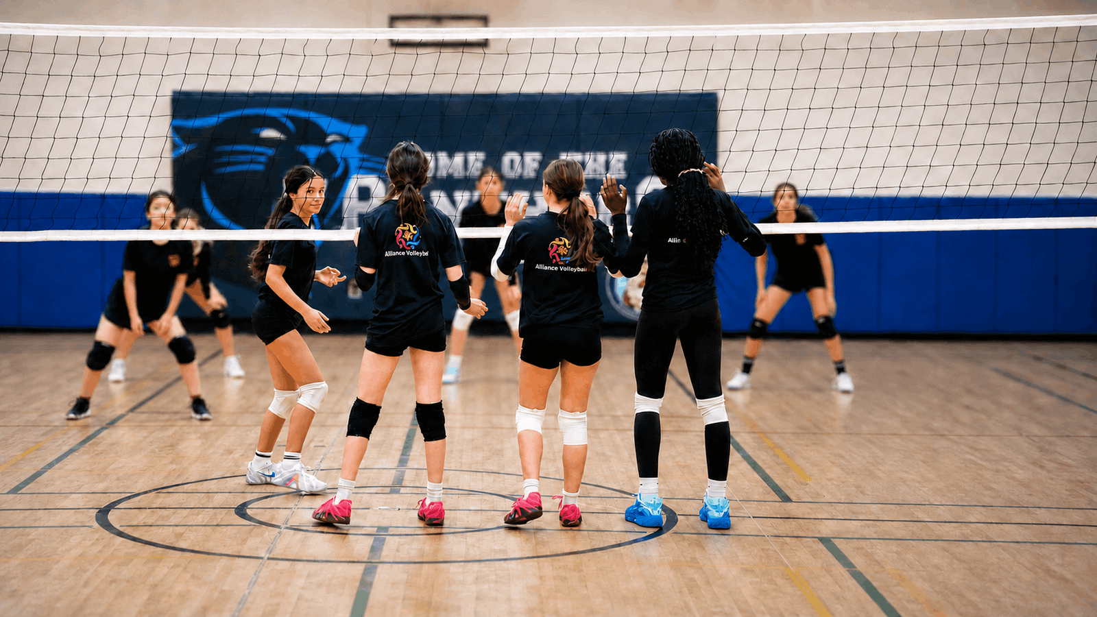 Alliance Volleyball athletes and coaches together in the gym